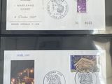 two envelopes with stamps on them are sitting on a table