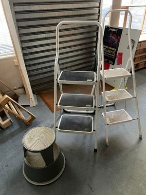 a ladder that is sitting next to a chair in a room