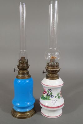 Deux lampes à pétrole, une en faïence de l'Est à décor de co…