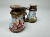two salt and pepper shakers sitting on a table