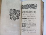 an open book with a black and white image of a floral design on it