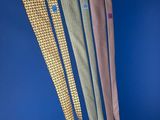 three different colored ties on a blue background with a blue background