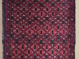 a red and black rug with a pattern on it