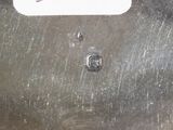 a close up of a piece of metal with a tag on it