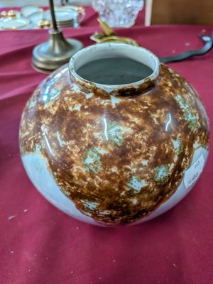 a vase that is sitting on a table with a red table cloth