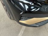 the front bumper of a black car with a gold stripe