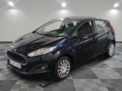 a black ford fiesta parked on a checkered floor in a garage