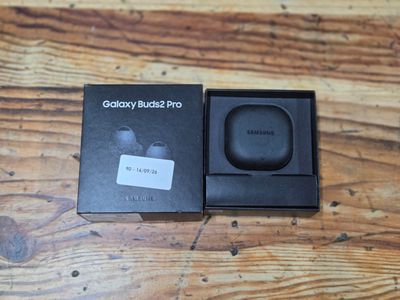 the samsung buds pro is in its box on a wooden table