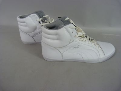 pair of white puma sneakers with grey laces on a white surface