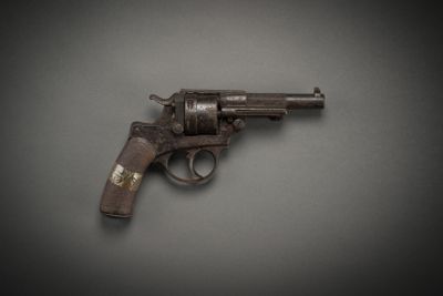 an old gun on a gray surface with a black background