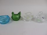 three different colored glass items sitting on a table