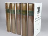 four books in a row on a table with a white background