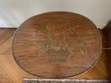 a wooden table with flowers on it in a room