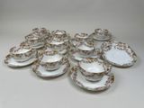 an image of a bunch of cups and saucers sitting on a table