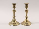 pair of antique brass candlesticks on a white background