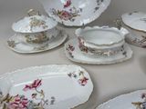 many different types of porcelain dishes and bowls on the table