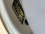 a close up of a toilet bowl with a sticker on it