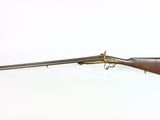 an old gun with a wooden barrel and a metal handle