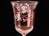 a wine glass with a design on it on a black background