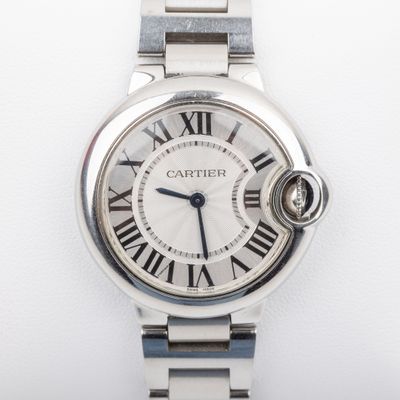 a close up of a wrist watch with roman numerals on it