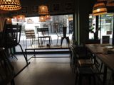 tables and chairs are lined up in a restaurant with a view of the street