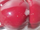 a red apple sitting on a white plate on a table