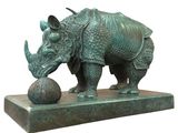 bronze sculpture of a rhino with a ball on a marble base