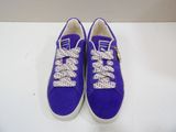 purple sneakers with white laces on them sitting on a white surface
