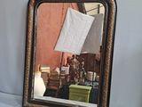 a mirror with a picture of a man and a woman in it