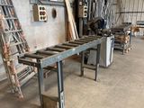a long table that is in a warehouse with ladders