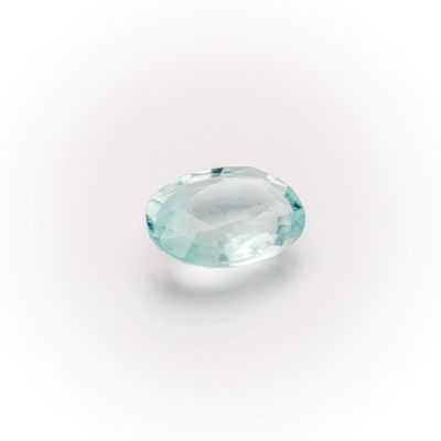 an oval aquamarinee gemstone on a white background