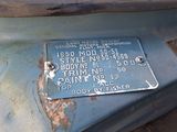 a plaque on the hood of a car that is rusted