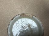 a dirty cup that is sitting on the floor