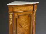 a small cabinet with a marble top on a stand