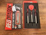 two red and white darts in a red box on a wooden table