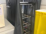 an image of a kitchen with a yellow trash can and a black bag