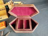 a small wooden box with a red velvet inside