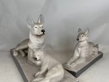two statues of a dog and a cat sitting on top of each other