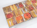 a coffee table with a metal base and a colorful tile top