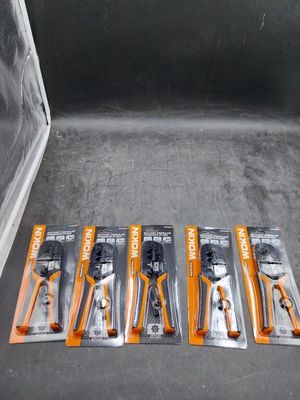 four pliers are sitting on the floor next to a package of pliers