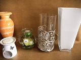 three vases and a book on a table