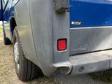 a blue van that is parked on the side of the road