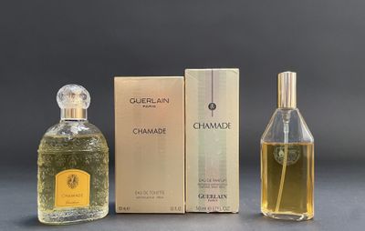 two bottles of perfume sitting next to each other on a table
