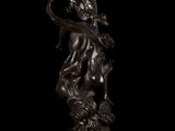 an image of a bronze statue of a woman holding a basket
