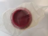 a plastic bag with a red liquid inside of it