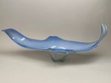 a blue glass bowl sitting on top of a white table