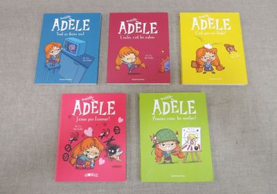 four children ' s books are lined up on a table