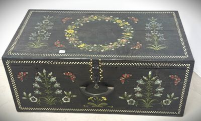 an old wooden box with a floral design on it