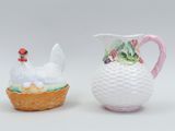 pair of porcelain figurines of chickens and a basket of strawberries