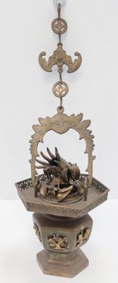 a bronze statue of a bird in a basket